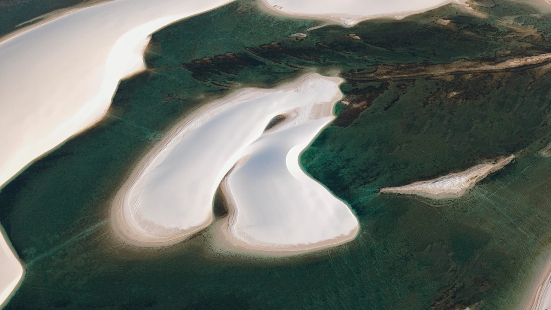 Sandbanks drawing shapes in the lagoons of Santo Amaro, aerial view