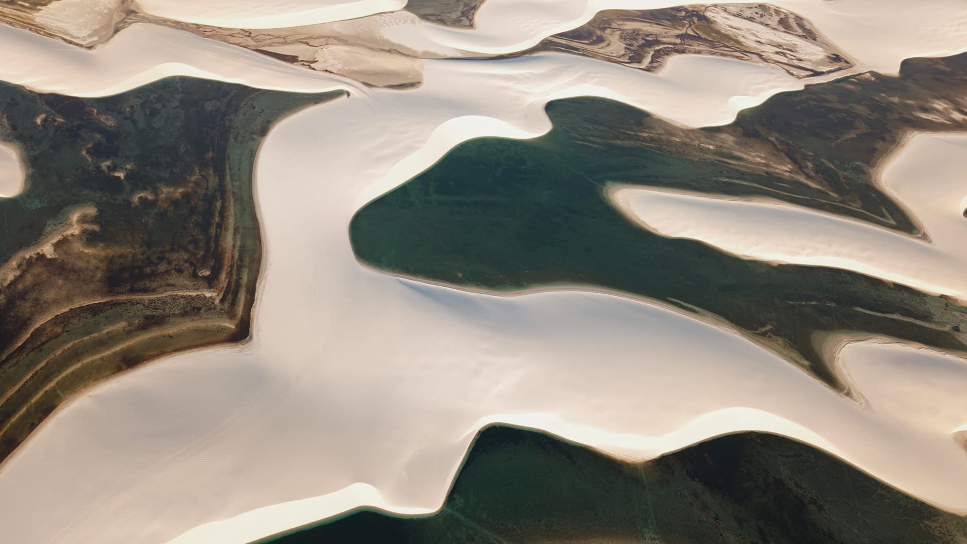 Mosaic of white dunes and green lagoons of Santo Amaro seen from above
